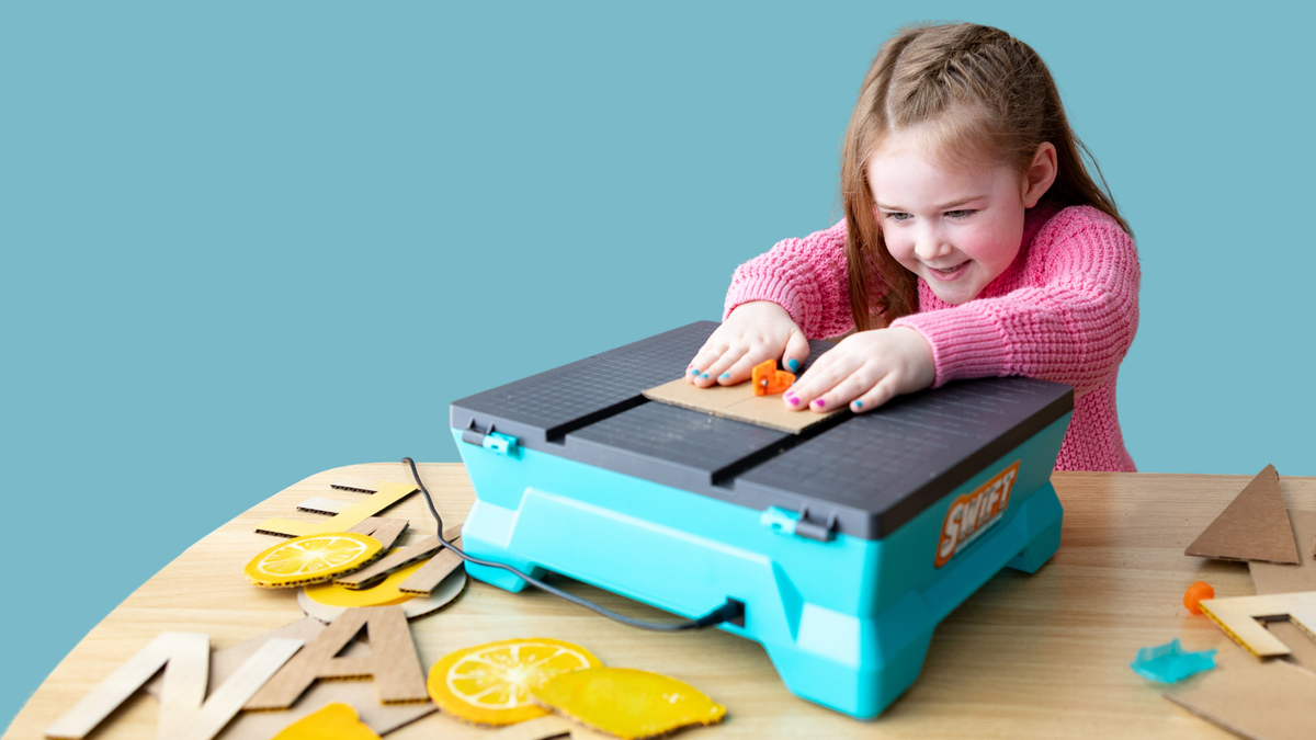 Girl cutting cardboard on the Swift Saw